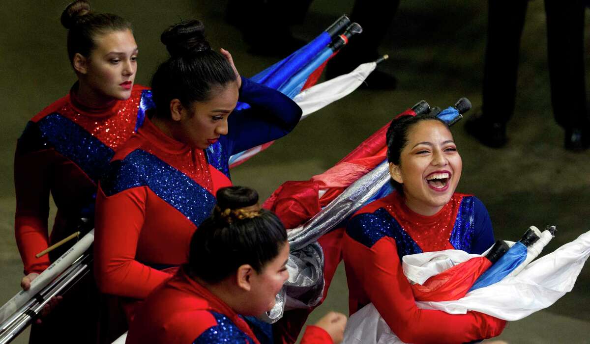 In this 2017 file photo, a member of the Porter High School flag line shares a laugh before competing in the UIL Marching Band State Championships at the Alamodome. Several New Caney ISD middle and high schools, including Porter, showed continued growth under the new Children At Risk academic rankings.