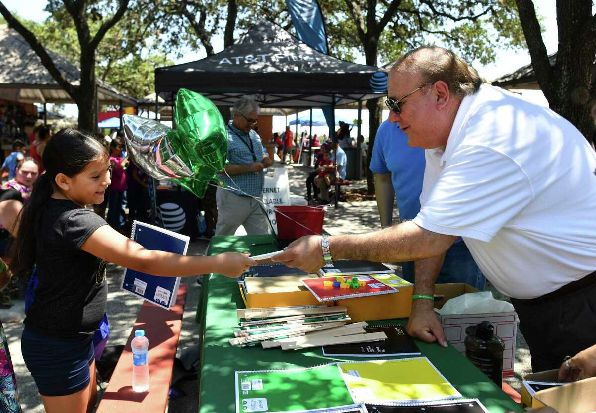 Bexar County Tax Assessor-Collector Albert Uresti passes out school supplies to students at Rosedale Park during the 13th annual Last Chance Ministries school backpack giveaway last August. Uresti was first elected tax assessor-collector in 2012.