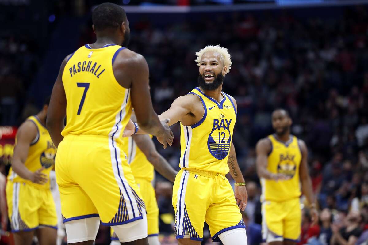 Golden State Warriors guard Ky Bowman (12) and Golden State Warriors forward Eric Paschall (7) in the second half of an NBA basketball game in New Orleans, Sunday, Nov. 17, 2019. The Pelicans won 108-100. (AP Photo/Tyler Kaufman)