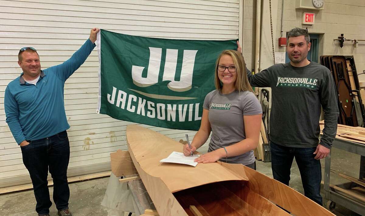 Madison Santabarbara is pictured above signing her National Letter of Intent letter with her father Michael Benz of Milford (right) and her chemistry teacher and Aquaculture School advisor Jan Pikul of Milford. Madison is signing her letter on top of a 25-foot sculling boat that she is building as part of a senior project at Aqua. She hopes to complete the project over the winter and race it competitively in a regatta in the spring.