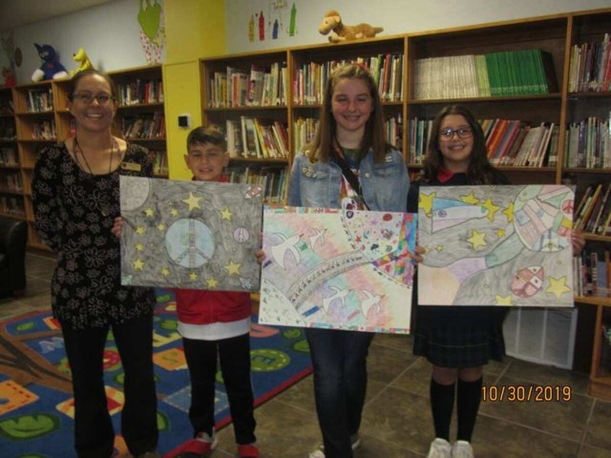 St. Ann’s School winners are Jake Jones, first place, from left, Claire Moore, second, and Suri Sledge, third. The art teacher is Marcia Crowder, far left.