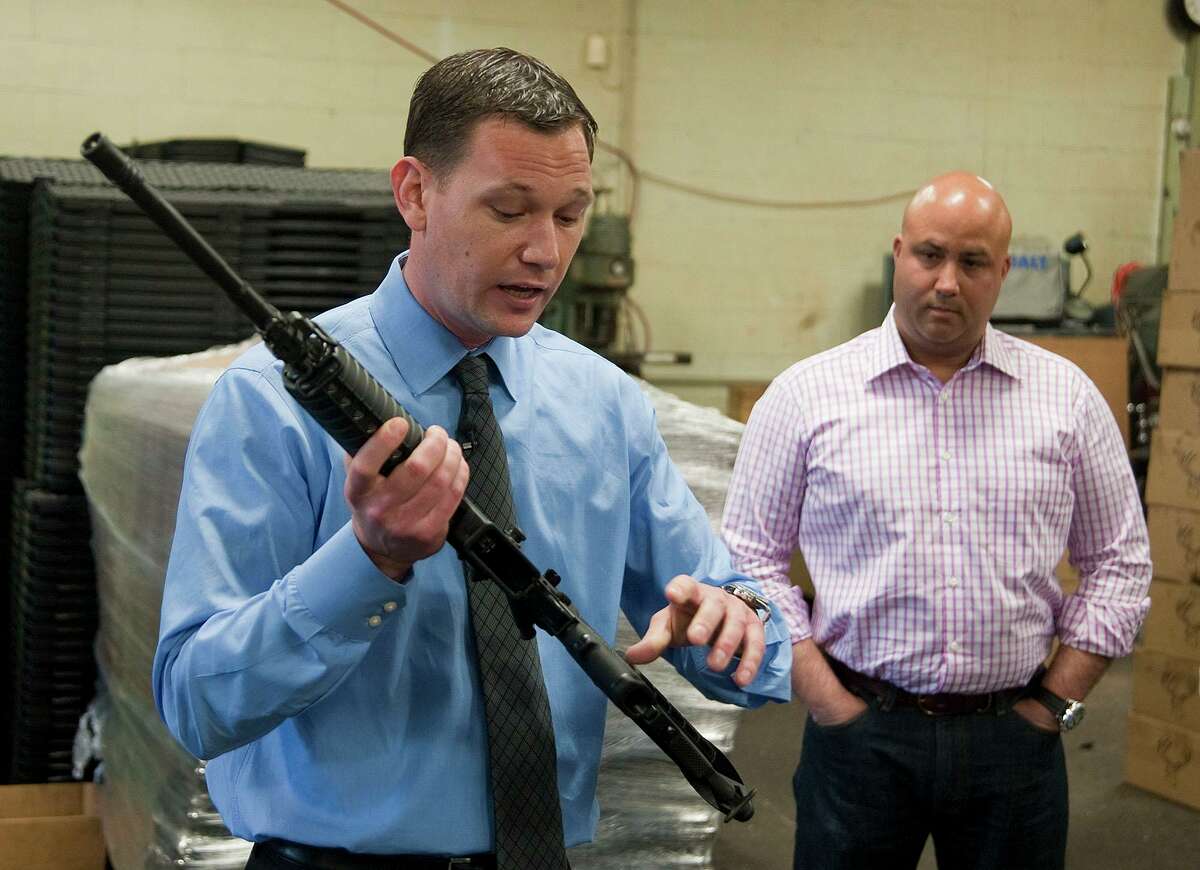 Mark Malkowski, owner of Stag Arms in New Britain, Conn. talks about his company's newly designed Stag-22, a weapon he says will be legal in the state of Connecticut, during a news conference on Thursday May 9, 2013. Looking on is John A. Napierski, Jr., owner of Jojo's Gun Works LLC in Southington, Conn. Malkowski says the reworked rifle should be legal because it uses a lower caliber bullet than the traditional AR-15, but the company was consulting police before going into production. Gun control advocates say the move violates the spirit of the new law, which expands Connecticut's assault weapons ban and bans large capacity ammunition magazines. (AP Photo/The Republican-American, Jim Shannon)