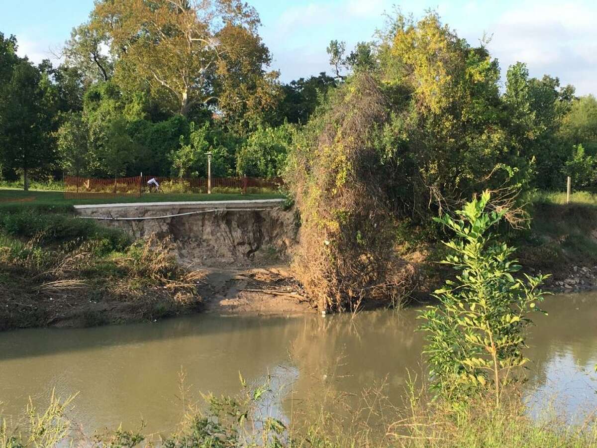Bank and sidewalk failure with irrigation pipes exposed on the north bank of Buffalo Bayou east of Waugh Drive, Oct. 28, 2019.