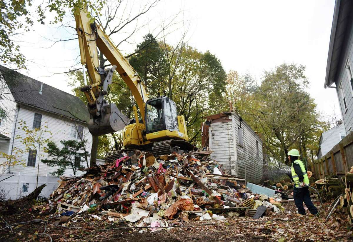 Crews demolish a blighted house at 46 Mead Ave. in the Byram section of Greenwich last November. Public concern over the house helped lead to a new blight ordinance that is headed to the RTM in September.