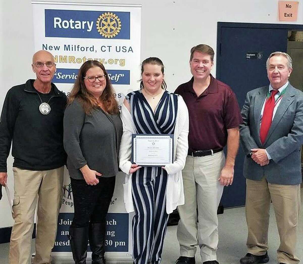 The Rotary Club of New Milford recently presented its September Student of the Month Award to Aurora Preusse. A senior at NMHS, Aurora has been goalie for the varsity field hockey team, a teacher's assistant in woodworking class, a member of NMHS chorus and worked on the NMHS musical scenery. She has a special interest in German history, language and culture. She plans to attend college and pursue a career in forensic psychology. Aurora, center, is shown above with, from left to right, Rotarian Tom McSherry, Aurora's parents, Carolin Preusse and Kevin Preusse, and NMHS teacher, James R. Wilson.
