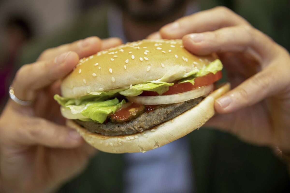 A customer eats a Rebel Whooper at a Burger King Holdings Inc. fast-food restaurant in Milan, Italy, on Tuesday, Nov. 12, 2019. Burger King started offering its meat-free Rebel Whopper across Europe on Tuesday in one of the largest product launches in its history and the first big restaurant deal for Unilever’s plant-based patty. Photographer: Camilla Cerea/Bloomberg