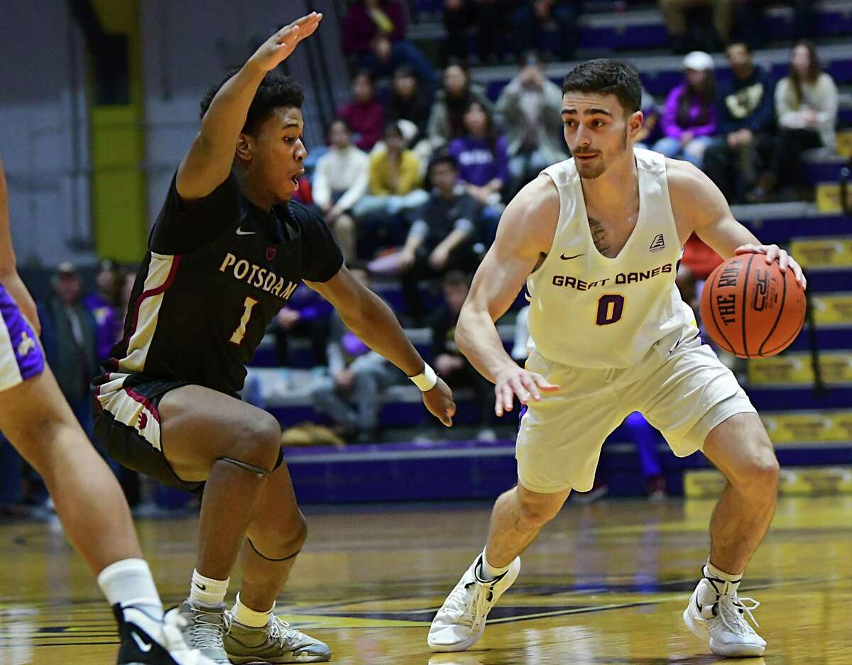 University at Albany's Antonio Rizzuto is defended by Potsdam's Jayquan Thomas during a basketball game at SEFCU Arena on Tuesday, Nov. 19, 2019 in Albany, N.Y. (Lori Van Buren/Times Union)
