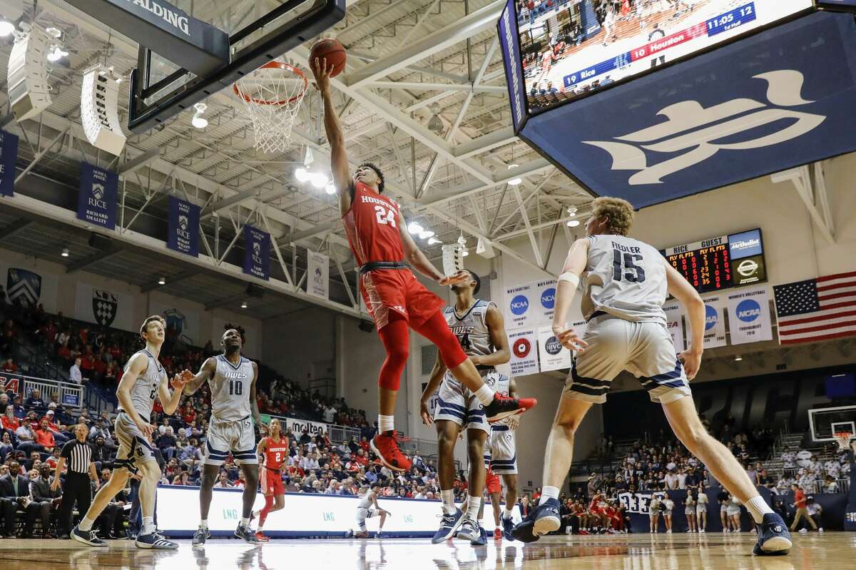 Houston Cougars guard Quentin Grimes (24) goes up for a lay up defended by Rice Owls guard Chris Mullins (24) during the first half of the NCAA basketball game between the Rice Owls and the Houston Cougars at Tudor Fieldhouse in Houston, TX on Tuesday, November 19, 2019. The Cougars defeated the Owls 97-89.