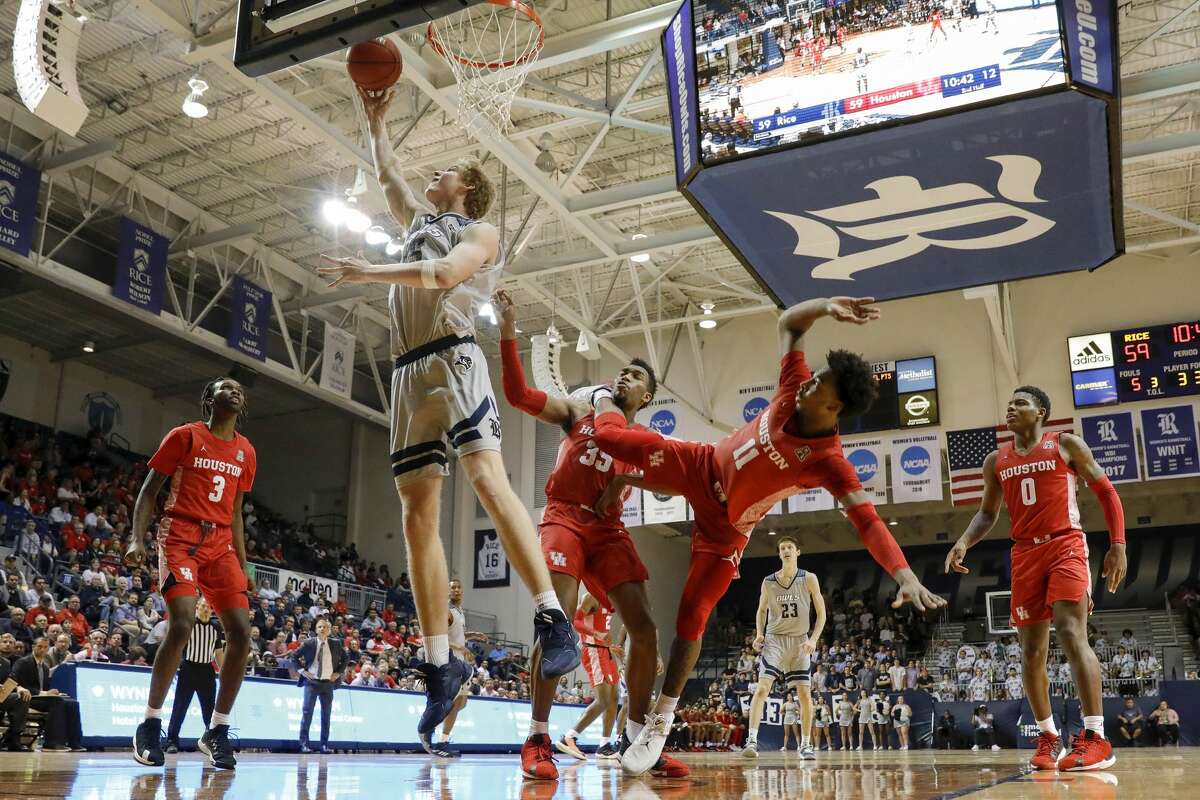 Rice Owls forward Max Fiedler (15) goes up for a lay up defended by Houston Cougars forward Fabian White Jr. (35) and guard Nate Hinton (11) during the second half of the NCAA basketball game between the Rice Owls and the Houston Cougars at Tudor Fieldhouse in Houston, TX on Tuesday, November 19, 2019. The Cougars defeated the Owls 97-89.