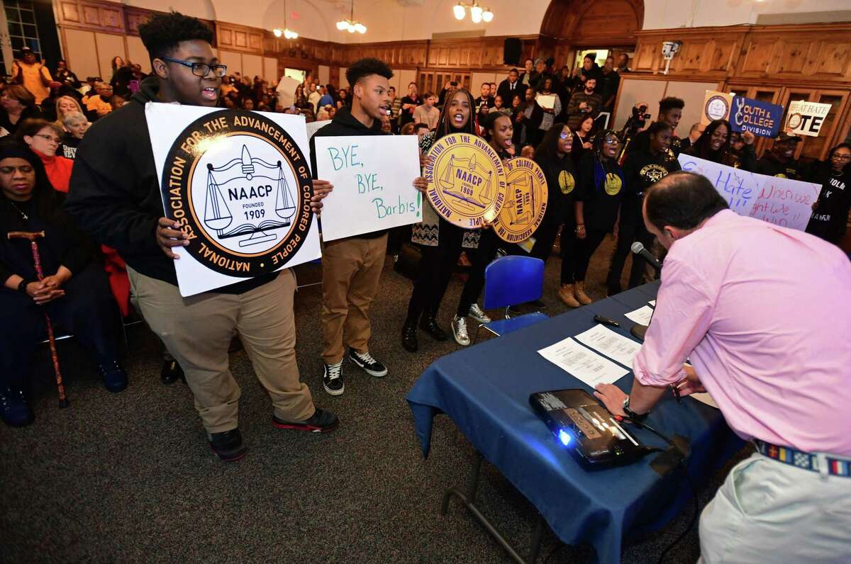 Members of the public, the NAACP and the Norwalk Board of Education square off at the Board of Education meeting Tuesday, November 19, 2019, where members were sworn in and the Norwalk NAACP urged the resignation of former BOE Chair Mike Barbis in the Norwalk City Hall Community Room in Norwalk, Conn.