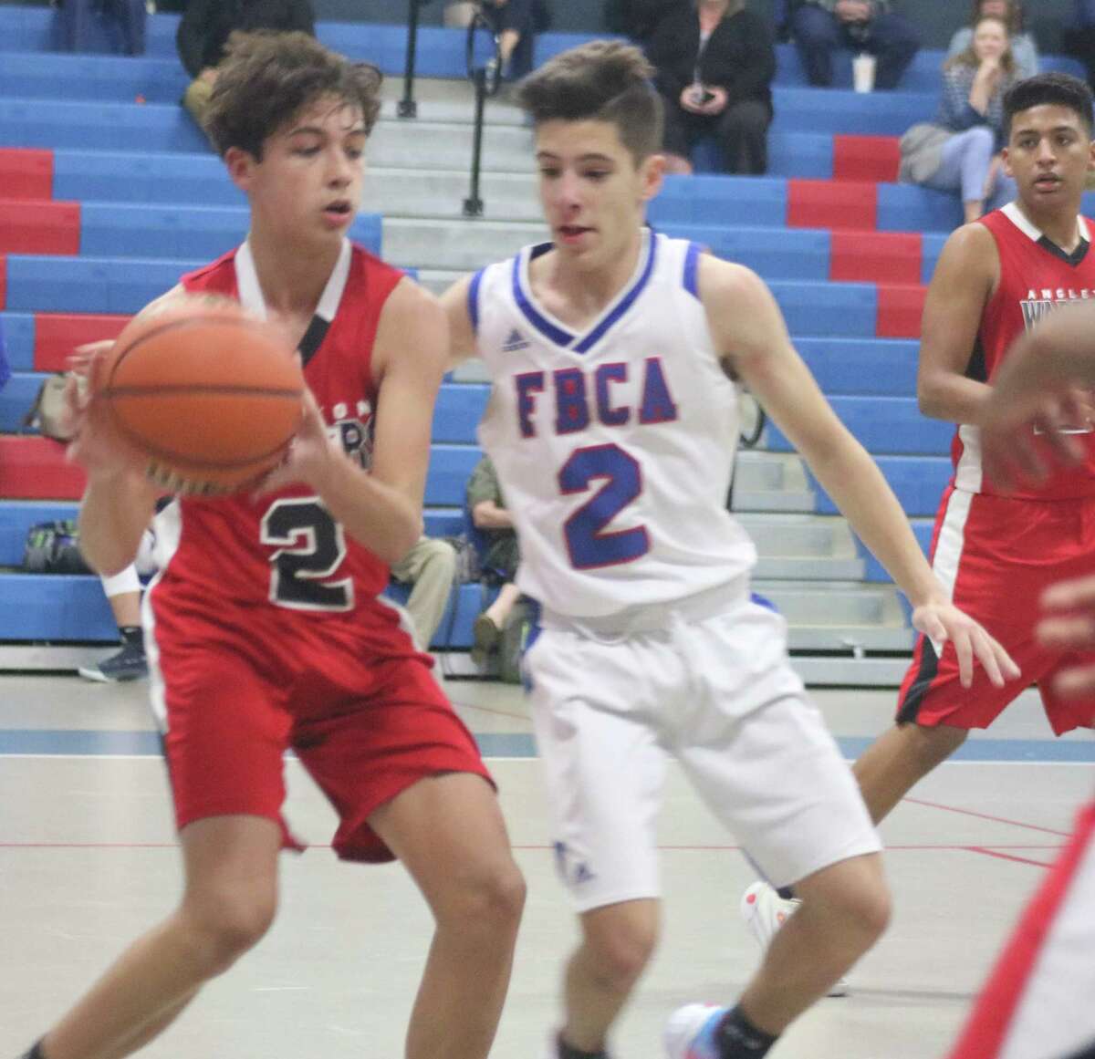 FBCA's Nick Gay applies front-court pressure on Angleton Christian's Jacob Soria during second-half action Tuesday night. Soria was the difference in the game, hitting four 3-point goals in the fourth quarter.