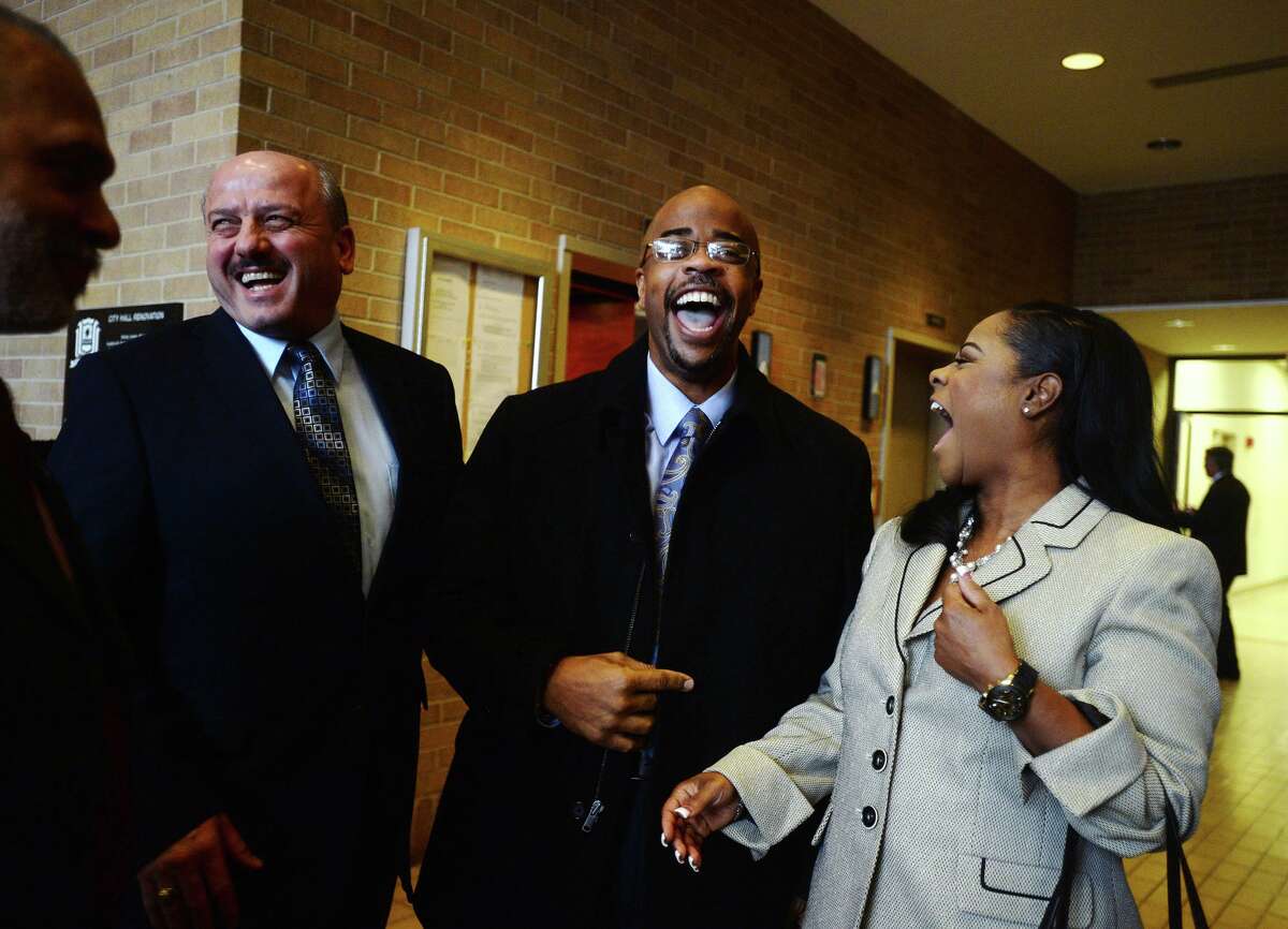 Dr. Joseph G. Majdalani, public works director, Jamie Smith, Jefferson County District Clerk, and Melanie Smith, left to right, share a laugh during a reception for William R. Sam, Sr., on Tuesday. Sam was sworn in as Ward IV councilman during the Beaumont City Council's normal meeting Tuesday afternoon. He is replacing Jamie Smith, who successfully ran for Jefferson County District Clerk, and will serve through the May election. Photo taken Tuesday 1/13/15 Jake Daniels/The Enterprise