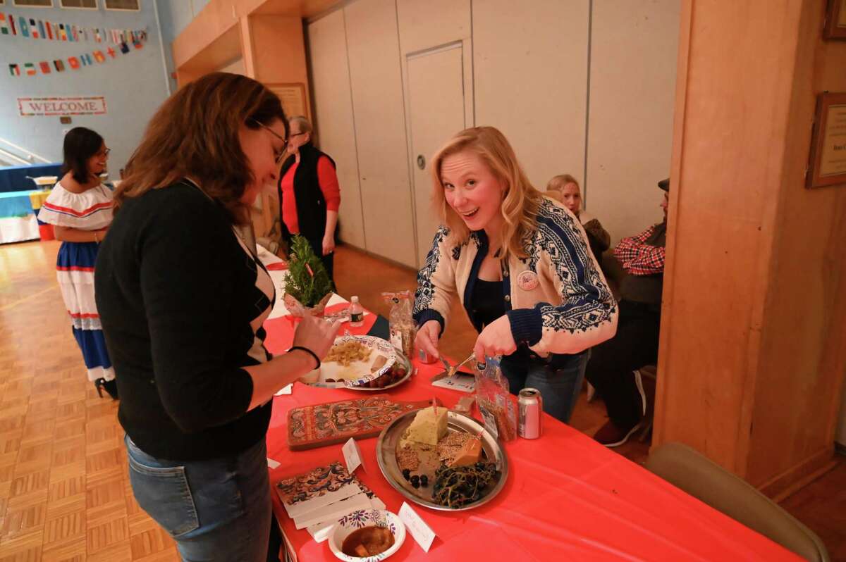 Mara Fleming, who is a member of the school board and church youth ministry serves Margaret Fleming O’Brien at Our Lady of Fatima Catholic Academy’s International Family Night on Nov. 16.