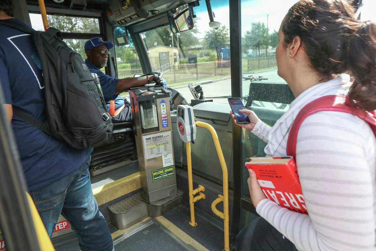 Metropolitan Transit Authority bus riders use Q cards, smartphone apps or cash to hop aboard a bus Nov. 20, 2019, in Houston. Metro is in the early steps of revamping its fare system. As part of the change, the agency is trying to phase out cash as much as possible.