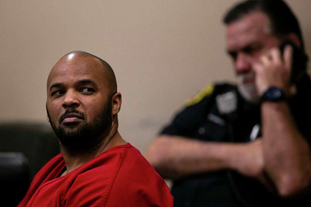 Emond Johnson looks over at people in the gallery during a hearing in the 186th District Court on Wednesday. Johnson is accused of setting the fire that killed firefighter Scott Deem and his lawyers argued that publicity surrounding the case has made it impossible for him to receive a fair trial in San Antonio.