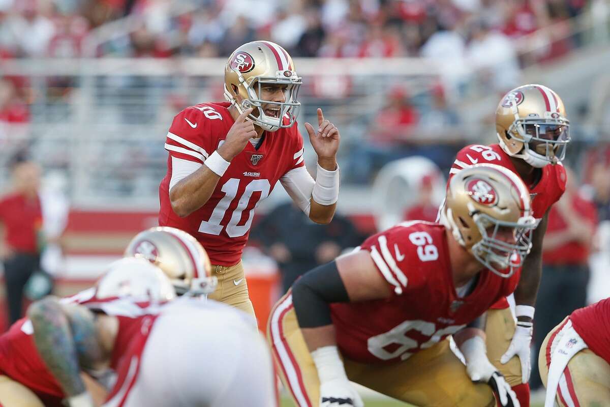 Quarterback Jimmy Garoppolo #10 of the San Francisco 49ers talks to teammates at the line of scrimmage in the fourth quarter against the Arizona Cardinals at Levi's Stadium on November 17, 2019 in Santa Clara, California. (Photo by Lachlan Cunningham/Getty Images)