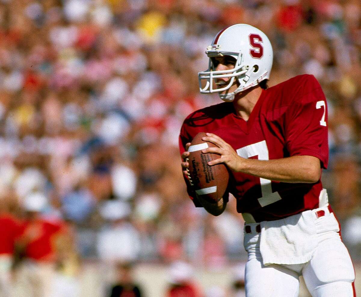 In this Oct. 1982 photo, Stanford University quarterback John Elway looks to pass during an NCAA college football game in Palo Alto.