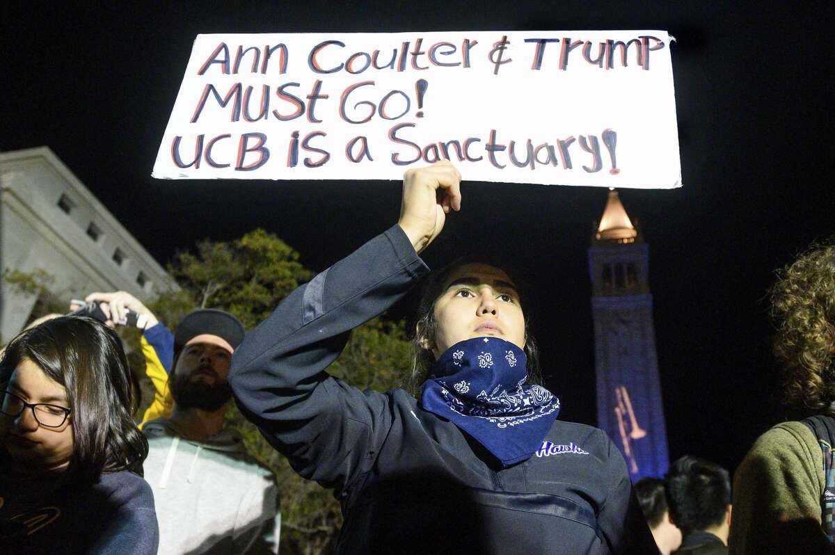 University of California, Berkeley student Magaly Mercado holds a protest sign as attendees leave a speech by conservative commentator Ann Coulter on Wednesday, Nov. 20, 2019, in Berkeley, Calif. Hundreds of demonstrators gathered on campus as Coulter delivered a talk titled "Adios, America!" (AP Photo/Noah Berger)