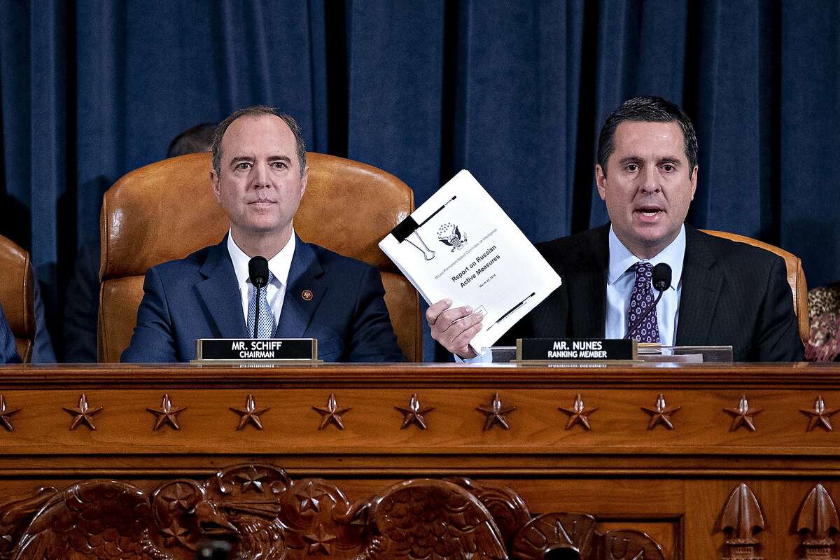 Rep. Devin Nunes, R-Calif., right, the ranking member of the House Intelligence Committee, joined by Chairman Adam Schiff, D-Calif., left, holds up a document he is submitting as the panel prepares to listen to former White House national security aide Fiona Hill, and David Holmes, a U.S. diplomat in Ukraine, on Capitol Hill in Washington, Thursday, Nov. 21, 2019, during a public impeachment hearing of President Donald Trump's efforts to tie U.S. aid for Ukraine to investigations of his political opponents.