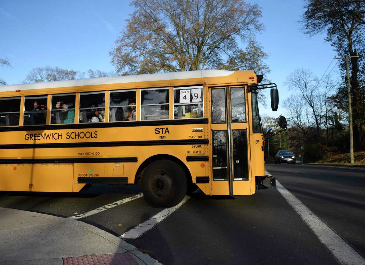 Buses depart during dismissal at Central Middle School in Greenwich, Conn. Thursday, Nov. 21, 2019.