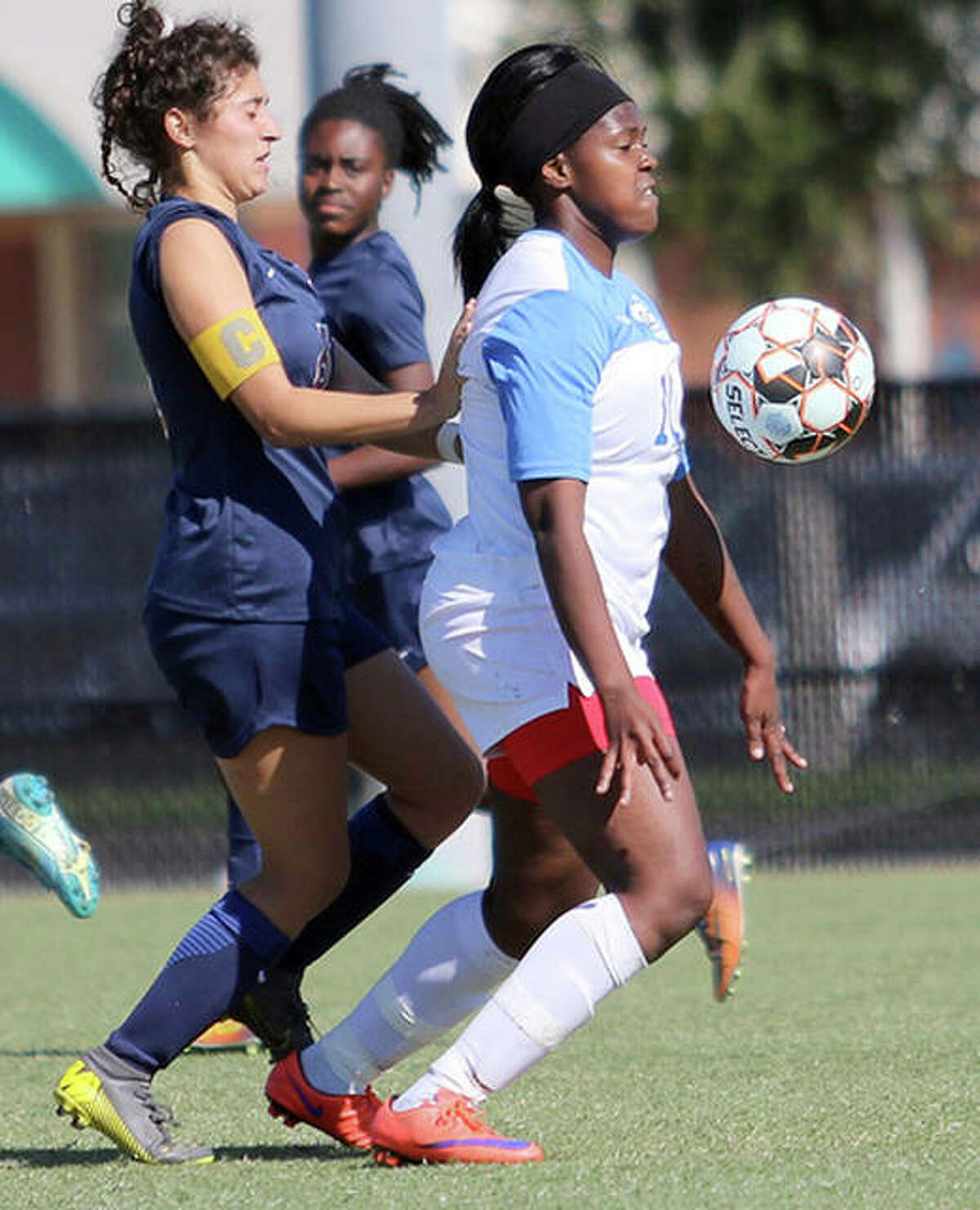Boitumelo Rabale of LCCC, right, settles the ball while being marked by a Hill College player Wednesday at the NJCAA National Soccer Tournament in Melbourne, Fla.