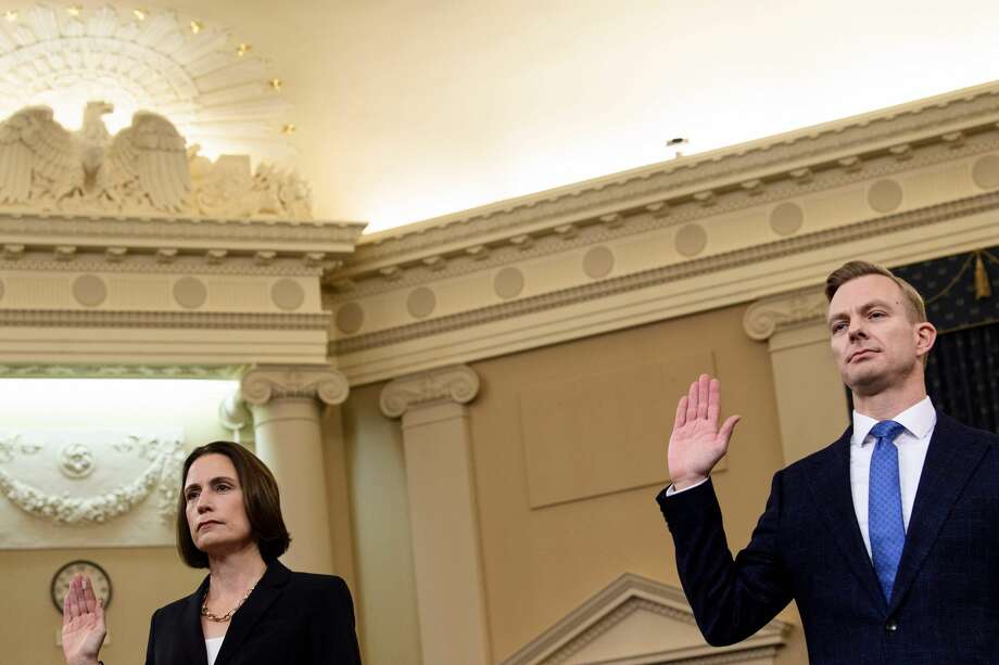 Fiona Hill, the former top Russia expert on the National Security Council, and David Holmes(C), a State Department official stationed at the US Embassy in Ukraine are sworn-in before they testify during the House Intelligence Committee hearing as part of the impeachment inquiry into US President Donald Trump on Capitol Hill in Washington,DC on November 21, 2019. (Photo by Brendan Smialowski / AFP) (Photo by BRENDAN SMIALOWSKI/AFP via Getty Images) Photo: BRENDAN SMIALOWSKI/AFP Via Getty Images