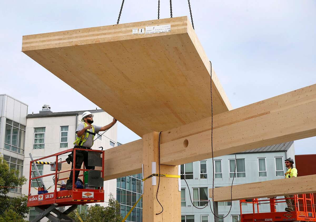 A cross-laminated timber floor panel is lowered into position for installation at an office building construction project in San Francisco, Calif. on Friday, Nov. 15, 2019. The One De Haro project is the first in the city to utilize the cross-laminated timber process.