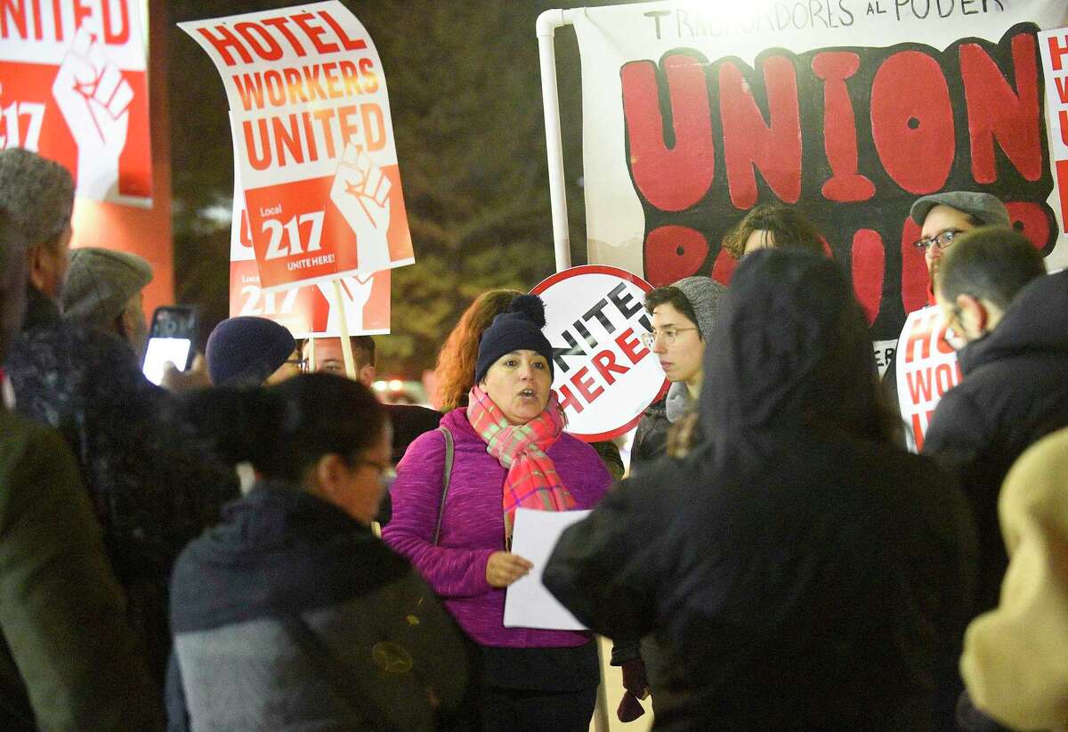 Mariela Sanchez, a housekeeper with the Sheraton Hotel, center, reads a prepared statement as she and several hotel workers from the hotel hold a rally on Nov. 21, 2019 in Stamford, Connecticut. Employees filed a formal complaint with OSHA on Thursday about unsafe working conditions at the hotel. Some of the allegations against the hotel administration is that workers say they are exposed to concentrated chemicals and are not given the appropriate protection from them. Late last year, employees voted to form a union by joining UNITE HERE Local 217 and have been vocal against hotel leadership.