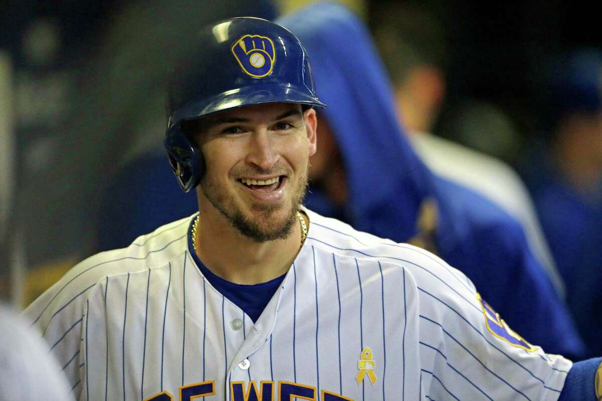 FILE - In this Sept. 7, 2019, file photo, Milwaukee Brewers' Yasmani Grandal smiles in the dugout after hitting a solo home run during the eighth inning of a baseball game against the Chicago Cubs, in Milwaukee. All-Star catcher Yasmani Grandal agreed to a $73 million, four-year contract with the Chicago White Sox, finding a more lucrative free-agent market now that he no longer is burdened by draft-pick compensation. Grandal will earn $18.25 million annually as part of the deal announced Thursday, Nov. 21, 2019. (AP Photo/Aaron Gash, File)