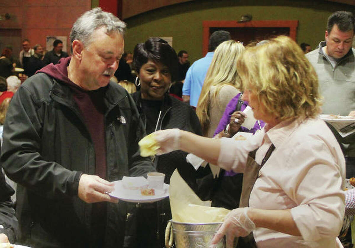 Jeff Norton, of Bunker Hill, gets chips from the Brown Bag Bistro at Taste of Downtown 2019, a fundraiser for Alton Main Street. About 400 people came out for the event, which included chances to taste samples from more than a dozen area restaurants, music and prizes.
