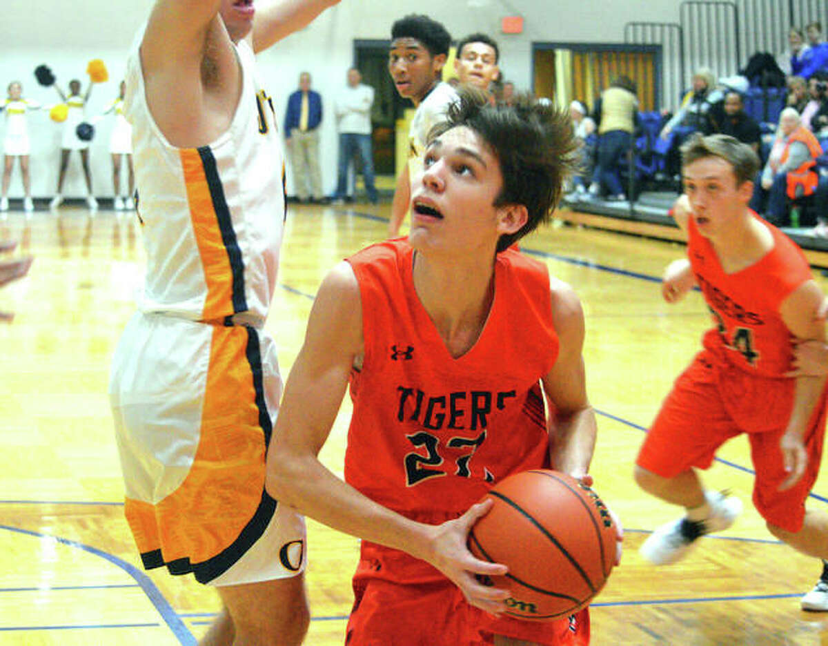 Edwardsville forward Brennan Weller looks for a shot from underneath the basket during a game at O’Fallon last season.