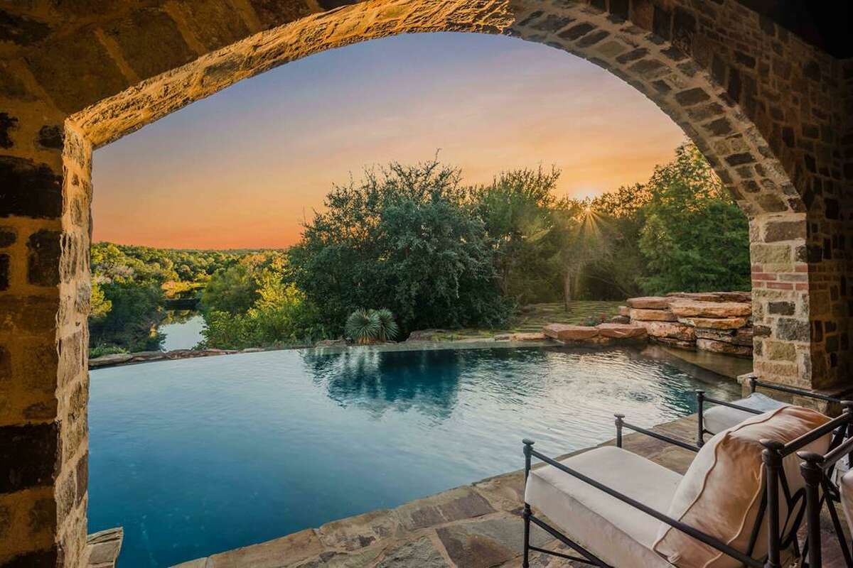 This Italian Villa-inspired ranch located six miles from Fredericksburg in the Texas Hill Country just hit the market at a whopping $13.9 million. Nestled behind 251 acres of natural scenery, the palatial estate boasts five bedrooms, five full and one half bathrooms, various outdoor patios, a detached game and media room, guest quarters, gourmet kitchen with an open fire pizza oven and infinity pool and hot tub that offers panoramic views of the serene landscape. Photo courtesy: Wingman Imagery