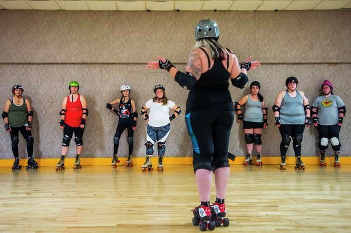 Emily Rewerts, co-captain of the Chemical City Derby Girls, center, explains to a group of "fresh meat" what they will be working on during their Oct. 7 practice at the Roll Arena in Midland. The "fresh meat training camp" is held for about 6 weeks each fall and allows women to give roller derby a try, with the possibility of joining the Chemical City Derby Girls. For more photos, turn to page 3A or go to www.ourmidland.com. (Katy Kildee/kkildee@mdn.net)