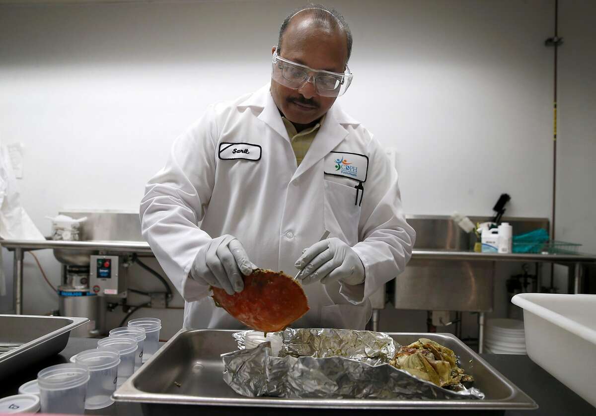 Sarit Gulati scrapes viscera from a Dungeness crab, one of six collected near Duxbury Reef, that will be tested for domoic acid levels at the California Department of Public Health lab in Richmond, Calif. on Tuesday, Nov. 19, 2019. The results of the test will help determine the opening date of the commercial crab fishing season in Northern California.