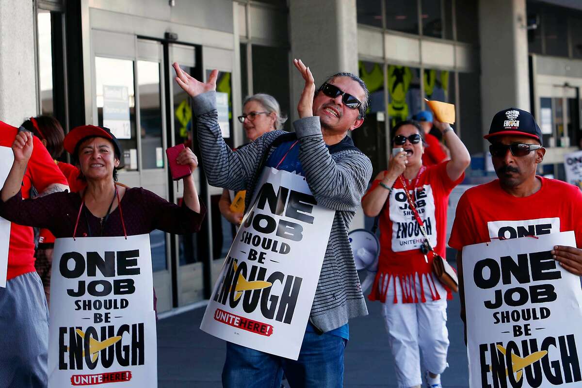 Nathanel Baquedano (front with hands raised clapping) cheers and pickets with other Unite Here members and supporters at Terminal 3 at San Francisco International Airport on Wednesday, September 25, 2019 in San Francisco, CA.