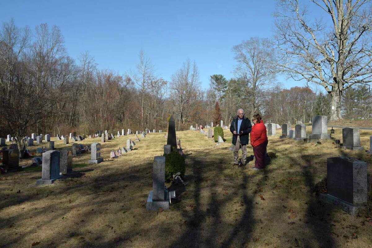 Jeff Nolan, with the Central Cemetery Association in Brookfield, talks with Mary Cipolla, who was visiting the cemetery. Nolan is advocating for cemeteries to be managed on a regional or state level. Thursday morning, November 21, 2019, in Brookfield, Conn.