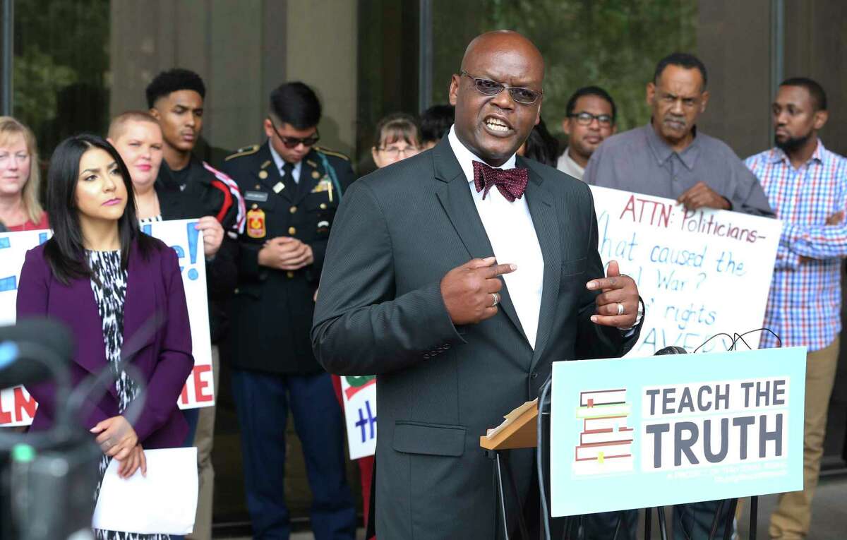 Board member Lawrence Allen steps away from proceedings to join demonstrators outside as the State Board of Education hears comments on proposed changes to the state's social studies curriculum at its meeting in Austin on September 11, 2018.
