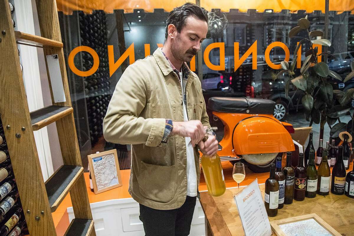 Tyler Kavanagh sets up a wine tasting at Biondivino, a wine shop on Russian Hill. Biondivino hosted a wine tasting on Tuesday, Nov. 19, 2019 in San Francisco, Calif.