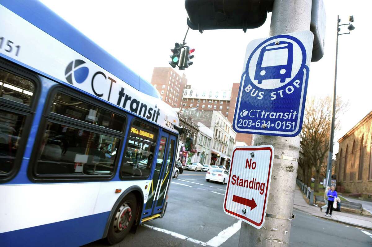A CT Transit bus pulls away from a bus stop on Chapel Street in New Haven on November 21, 2019.