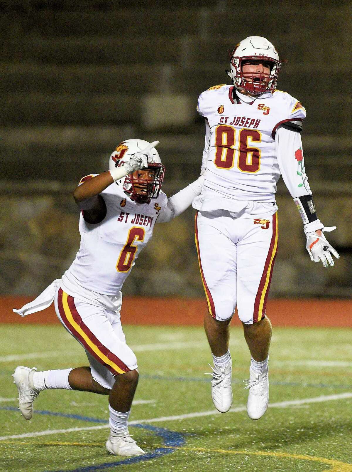 St. Joseph Noah Gage (6) celebrates with teammate Owen DaSilva (86) after DaSilva recovered a fumble on a botch Stamford punt snap in the endzone for a touchdown in the first quarter of a FCIAC football game against Stamford at Boyle Stadium on Nov. 22, 2019 in Stamford, Connecticut. St. Joseph won 58-0.