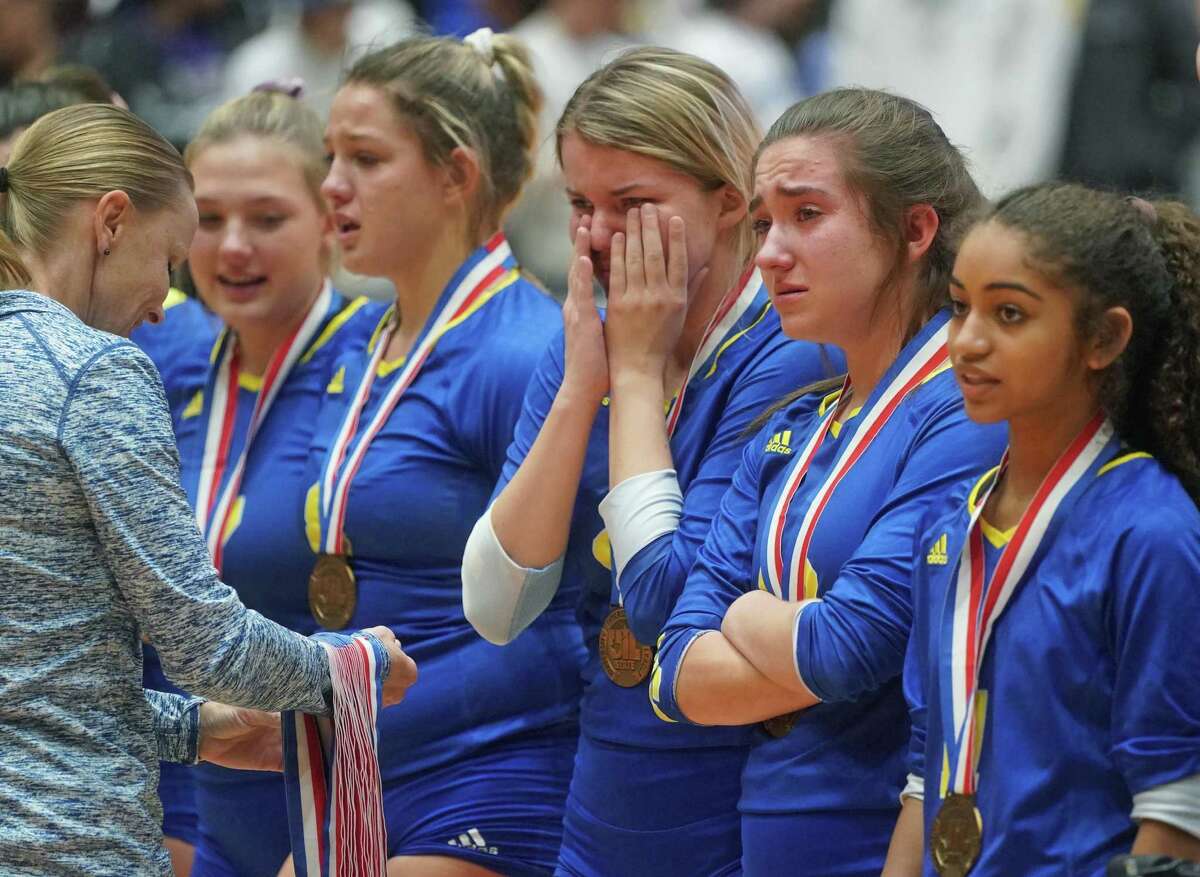 Clemens' teammates Rylee Thomas, Canada Buchanan, Kayla Teeler, Danielle Stephenson-Pino and Mia Bartholomew, left to right, line up sadly to receive their medals after the Schertz Clemens High School vs. Northwest Byron Nelson High School state semifinal volleyball match on Friday, November 22, 2019 at the Curtis Culwell Center in Garland, Texas. Nelson won 3 games to 0. CREDIT: Louis DeLuca for the San Antonio Express News