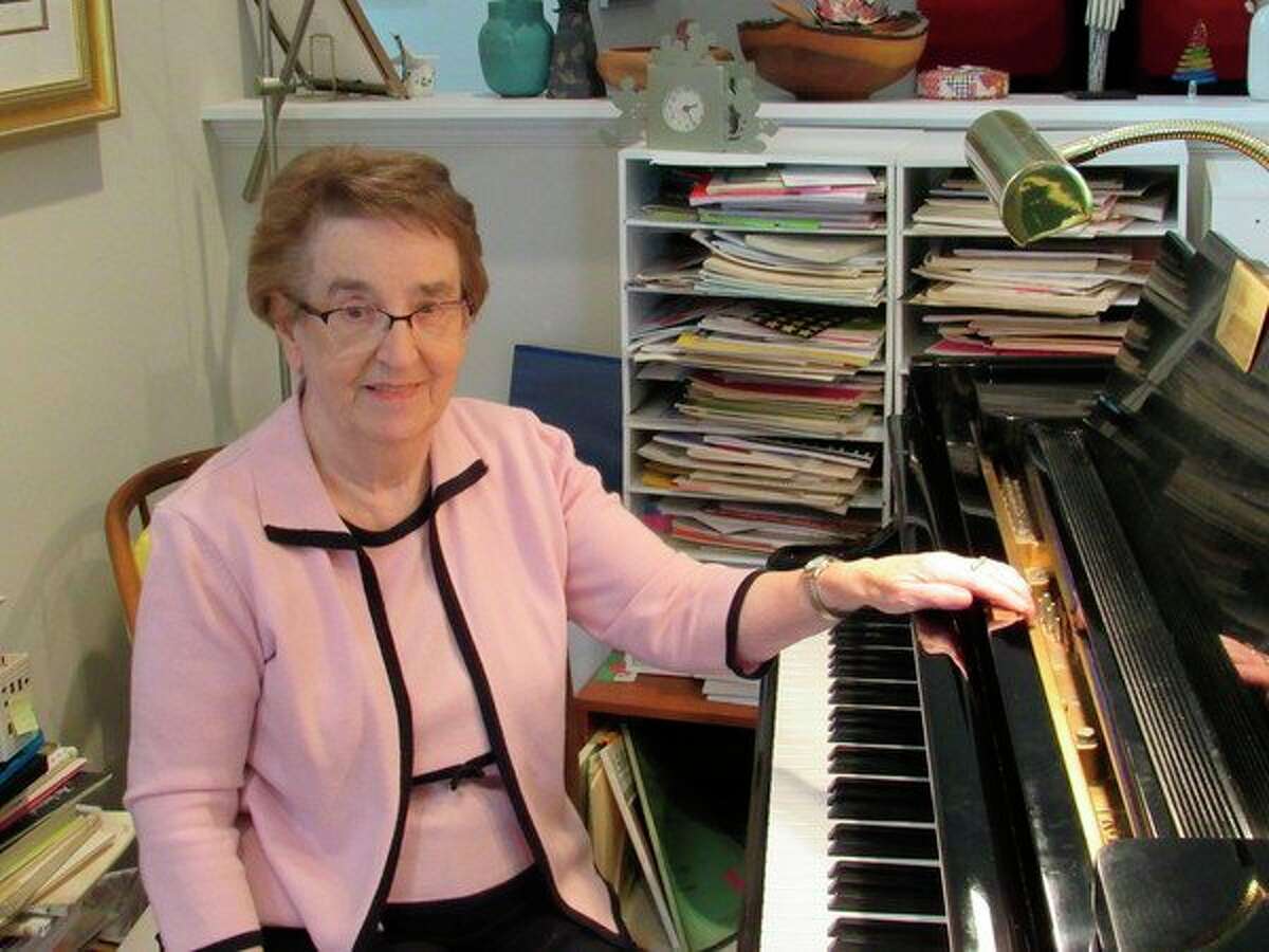 Mair Alsgaard, of Midland, poses by her piano in her home studio in this 2019 file photo. Alsgaard died on June 17, 2022.