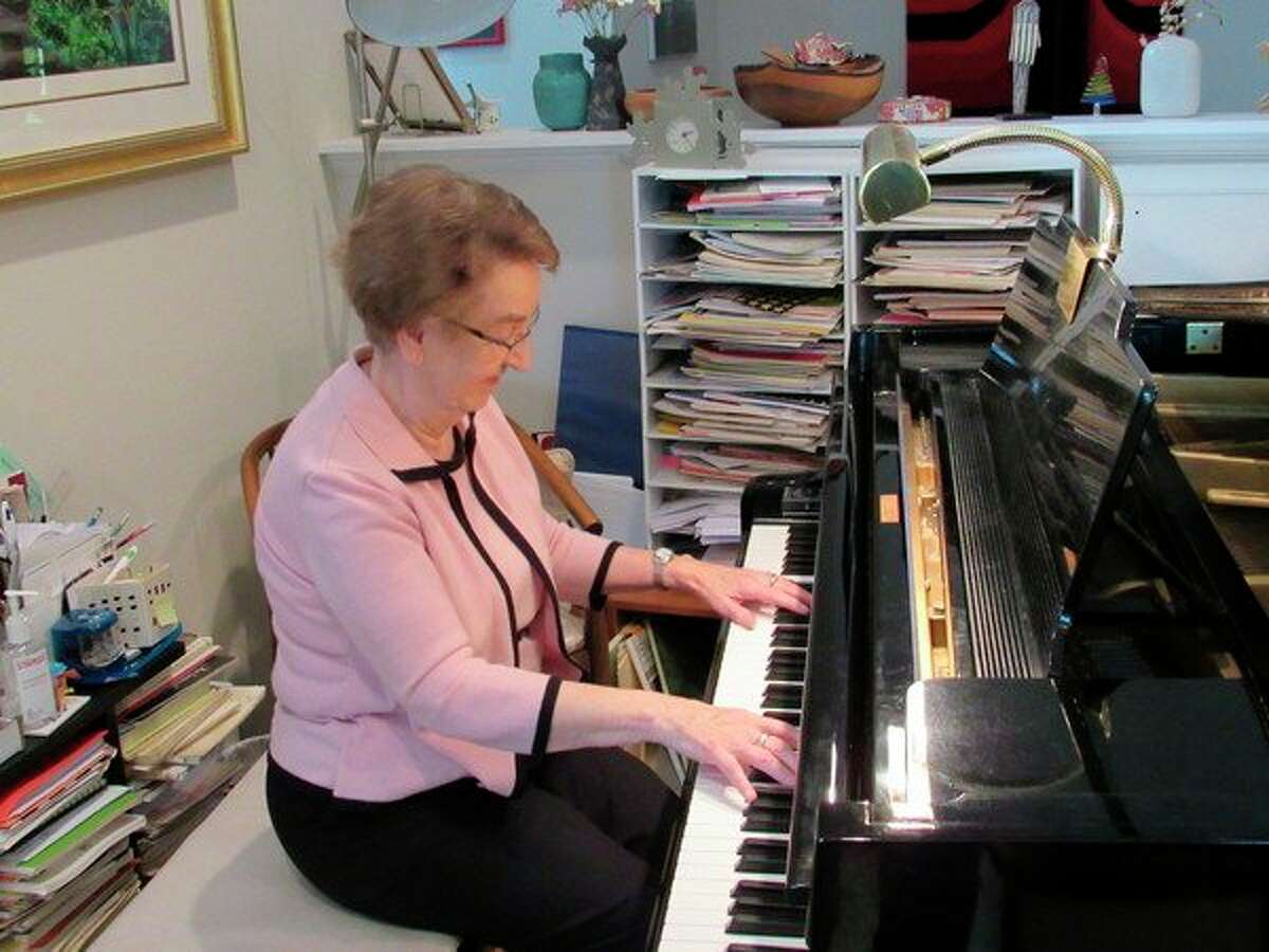 Mair Alsgaard, of Midland, plays the piano in her home studio in this 2019 file photo. Alsgaard died on June 17, 2022.