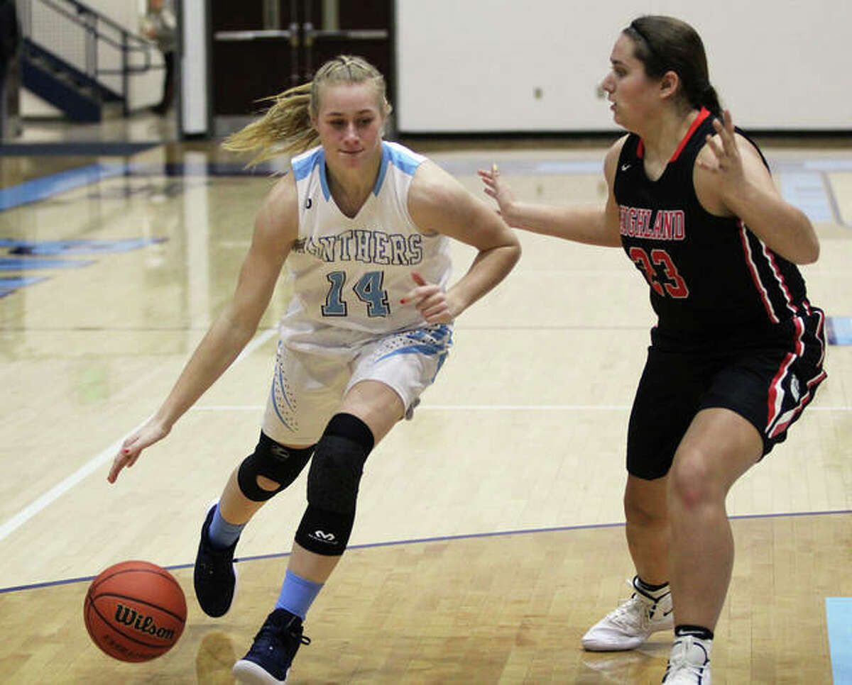 Jersey’s Lauren Brown (left) drives on Highland’s Taylor Kesner during a game last season in Jerseyville. On Friday night at the Alton Tournament, Brown scored a career-high 16 points to help the Panthers beat Breese Mater Dei.
