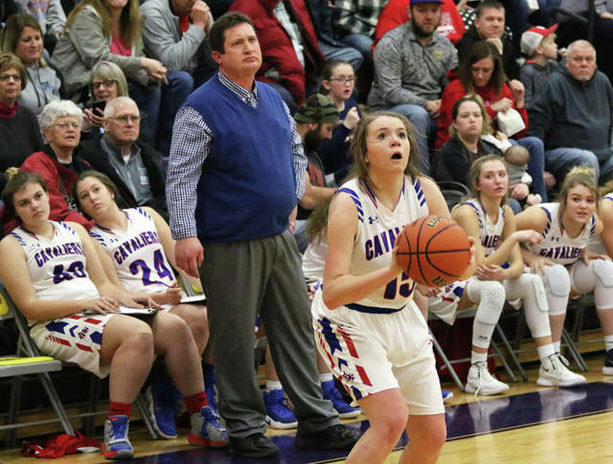 Carlinville’s Gracie Reels sets to launch a 3-pointer in front of coach Darrin DeNeve and the Cavaliers bench during a game last season. Reels scored a career-high 14 points in the Cavs win over Brussels on Friday night at the Carlinville Tip-Off Classic.