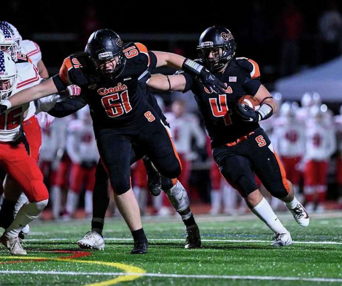 Georgio Ghazal follows Craig Ferris through the hole during Shelton's victory over Fairfield Prep.