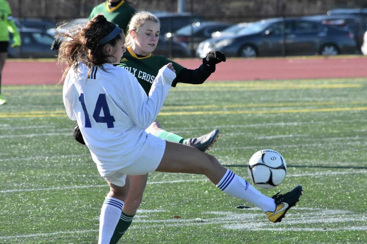Holy Cross’ Alexa Diorio and Old Lyme’s Abigail Manthous battle for the ball during the Class S girls soccer State Championship at Veterans Stadium, New Britain on Saturday, Nov. 23, 2019. (Pete Paguaga, Hearst Connecticut Media)