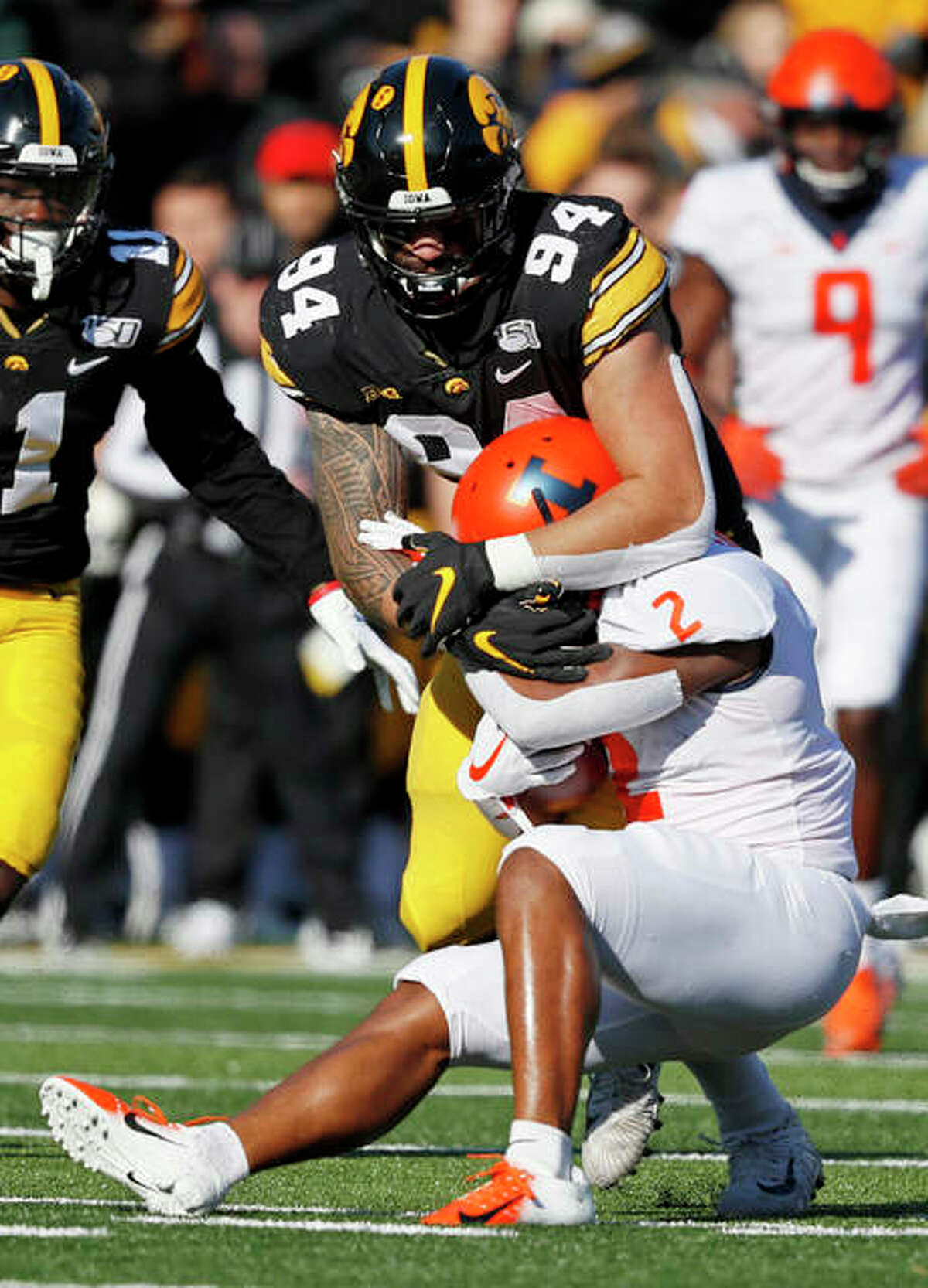 Illinois Reggie Corbin is tackled by Iowa defensive end A.J. Epenesa (94), a junior from Edwardsville, during the first half Saturday in Iowa City, Iowa.
