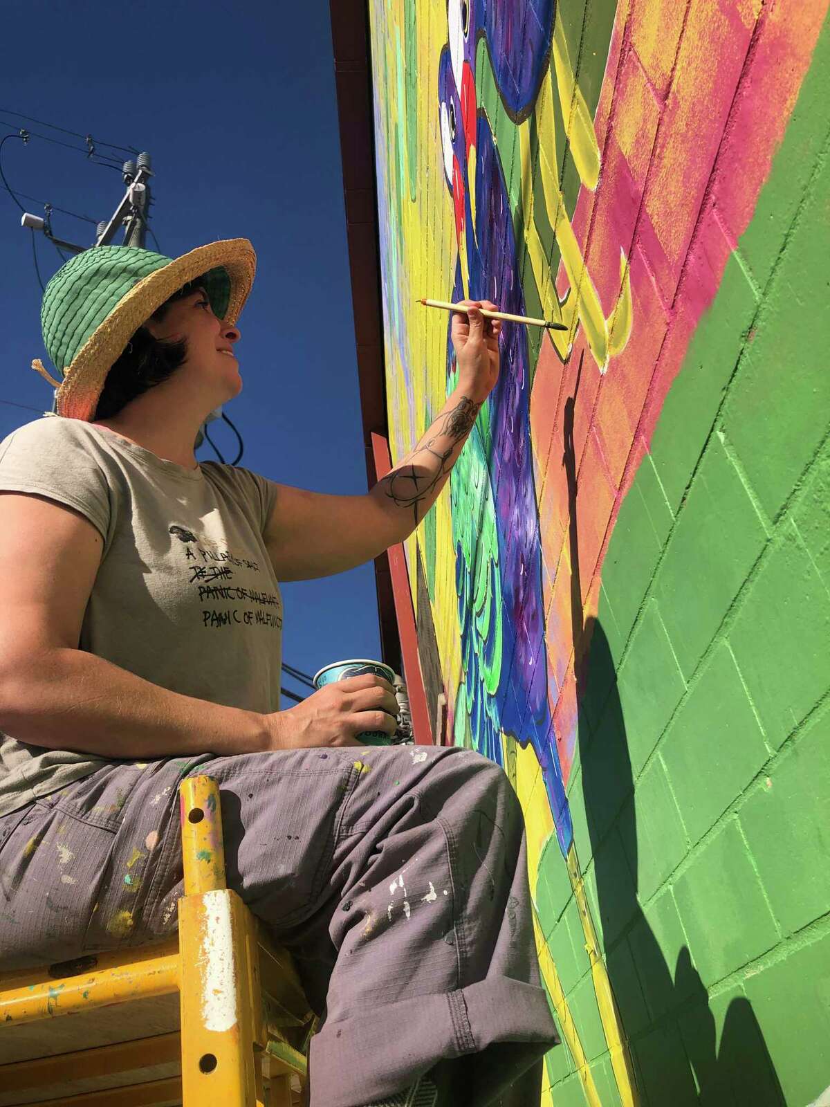 New York-based artist Jana Liptak paints details on her mural in the alley behind Saint Arnold Brewery.