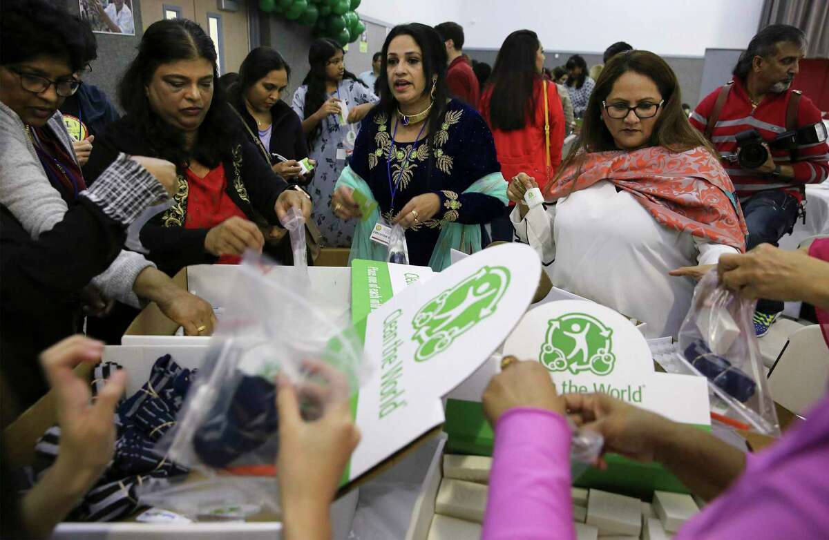 Pressanna Parackal (center), registered nurse and president of the San Antonio Indian Nurses' Association, joins others in assembling 1000 hygiene kits that will be donated to Haven for Hope and Child Advocates San Antonio as part of the association's inaugural conference & gala on Saturday, Nov. 23, 2019. The hygiene kits contained shampoo, conditioner and bar soap that was recycled by the organization Clean the World, which donates cleaning products that large hotels would otherwise discard. Also in each kit was a pair of socks, a toothbrush and tooth paste and a handwritten inspirational note from the group’s volunteers.